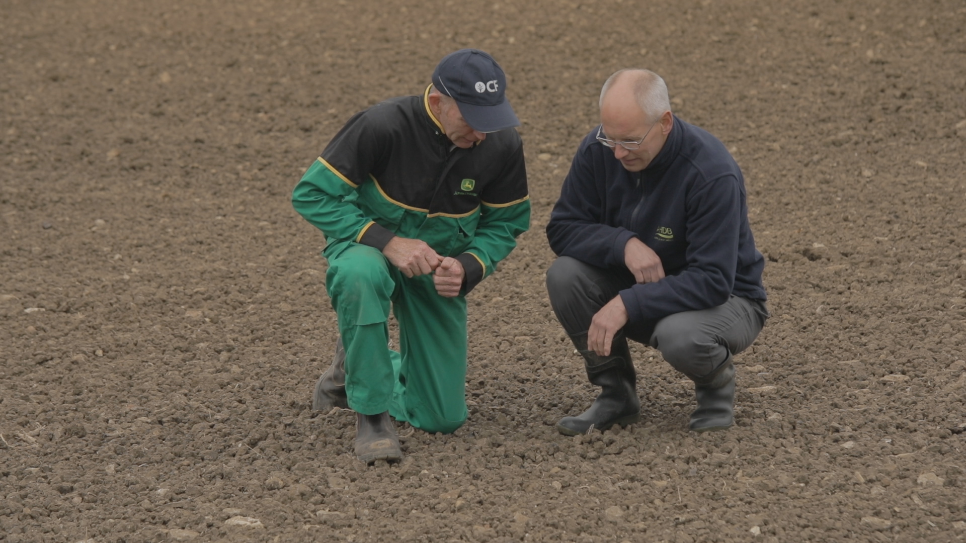 Roger Wilson (left) and Philip Dolbear (right) look at soil